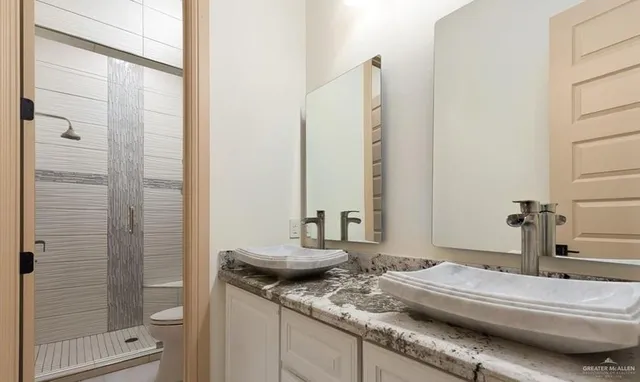 a bathroom with a toilet a sink and a mirror