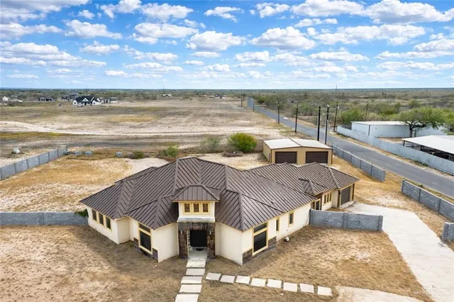 a view of a dining room with furniture and a chandelier