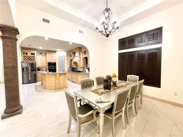 a living room with furniture a flat screen tv and a refrigerator