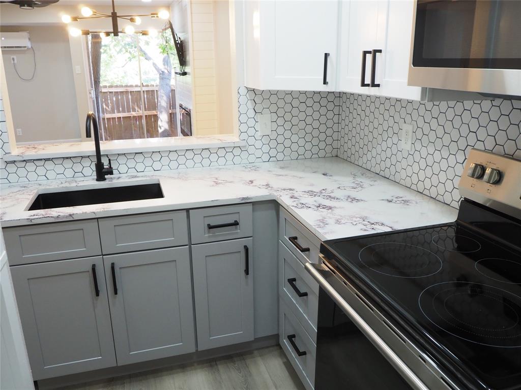 a kitchen with a sink stove and cabinets