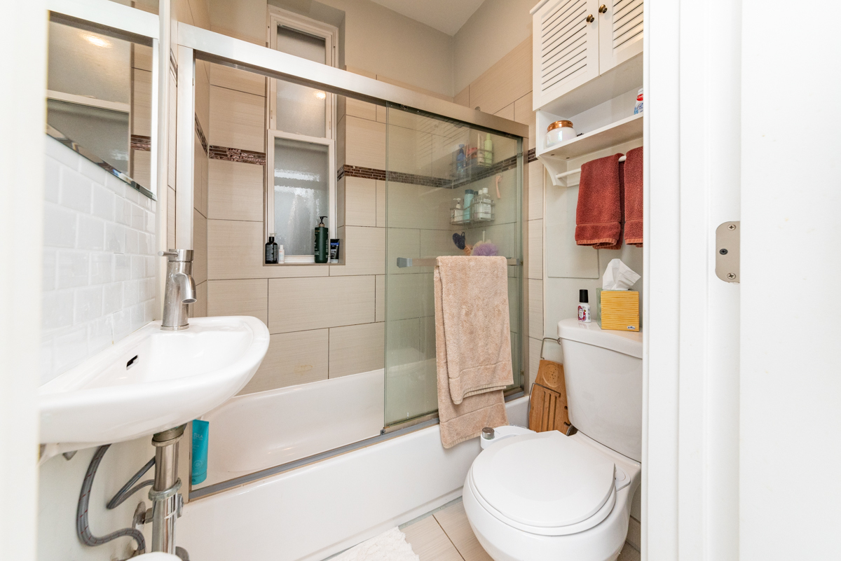 2145 West Webster Avenue, Unit 2 Chicago, IL 60647 - Photo 12 of 13 a white toilet sitting next to a bathroom sink