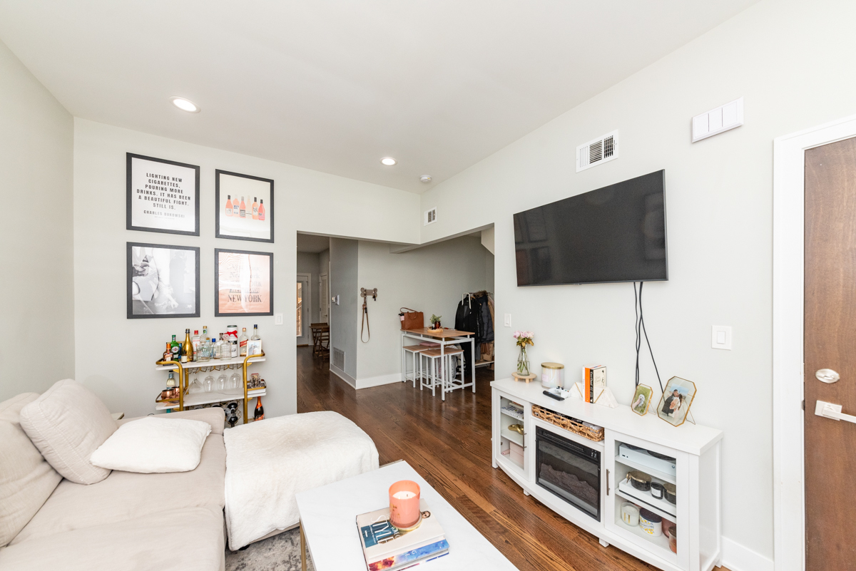 2145 West Webster Avenue, Unit 2 Chicago, IL 60647 - Photo 6 of 13 a living room with furniture and a flat screen tv