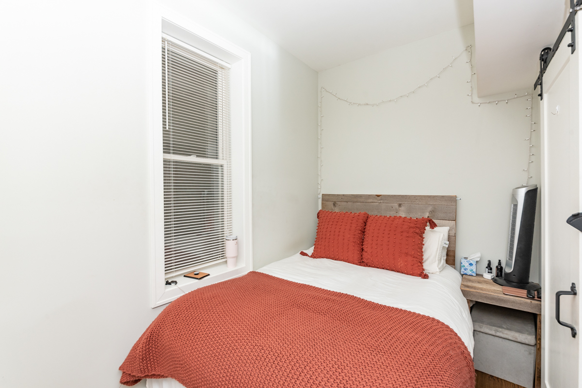 2145 West Webster Avenue, Unit 2 Chicago, IL 60647 - Photo 9 of 13 a bedroom with a bed and a flat tv screen