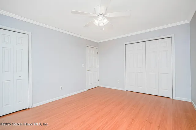 an empty room with a ceiling fan and a window