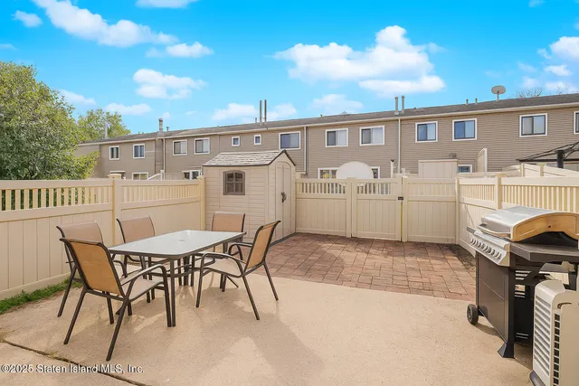 a view of a dinning table and chairs in patio of the house