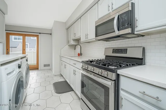 a kitchen with cabinets stainless steel appliances and a sink