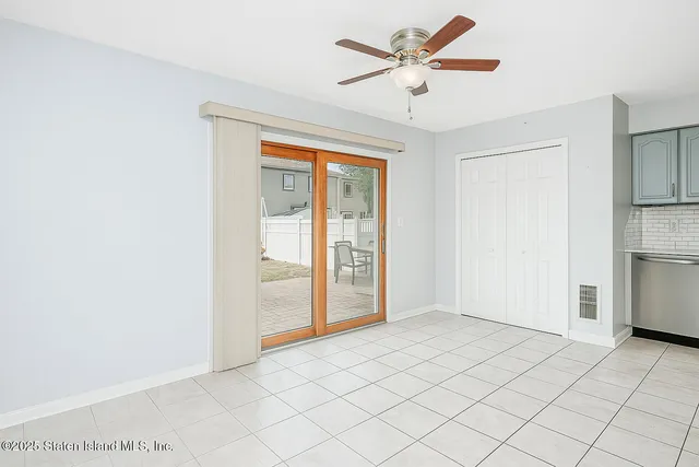 a view of a livingroom with a ceiling fan and window
