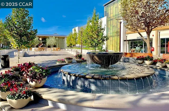 a view of a dining table and chairs in the patio in front of a house