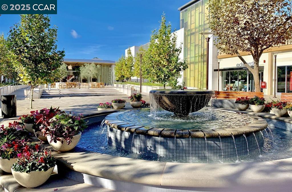 1220 Walker Avenue, Unit 3 Walnut Creek, CA 94596 - Photo 22 of 26 a view of a dining table and chairs in the patio in front of a house