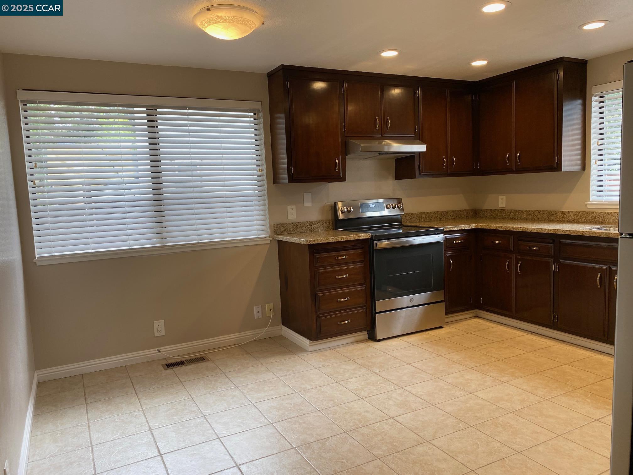 1220 Walker Avenue, Unit 3 Walnut Creek, CA 94596 - Photo 7 of 26 a kitchen with stainless steel appliances granite countertop a sink and a stove