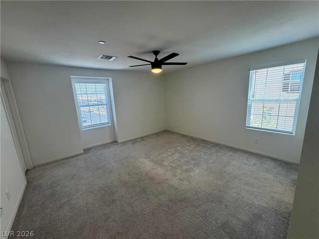2821 Alcobaca Street Henderson, NV 89044 - Photo 20 of 24 A well-lit, neutral-toned room provides a blank canvas for personalization.
