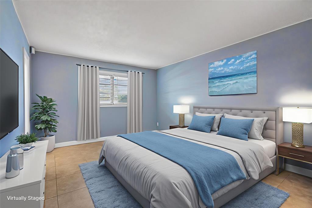 1759 Northeast 40th Place, Unit 604 Pompano Beach, FL 33064 - Photo 12 of 24 a bedroom with bed and a potted plant