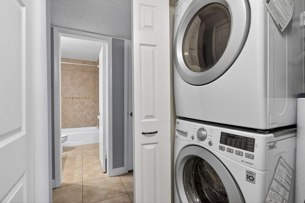 1759 Northeast 40th Place, Unit 604 Pompano Beach, FL 33064 - Photo 15 of 24 a view of a storage and utility room with dryer and washer