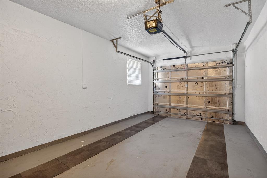 1759 Northeast 40th Place, Unit 604 Pompano Beach, FL 33064 - Photo 18 of 24 an empty room with wooden floor and windows