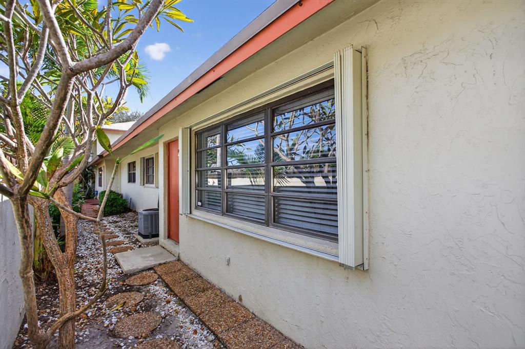 1759 Northeast 40th Place, Unit 604 Pompano Beach, FL 33064 - Photo 19 of 24 a house with trees in front of it