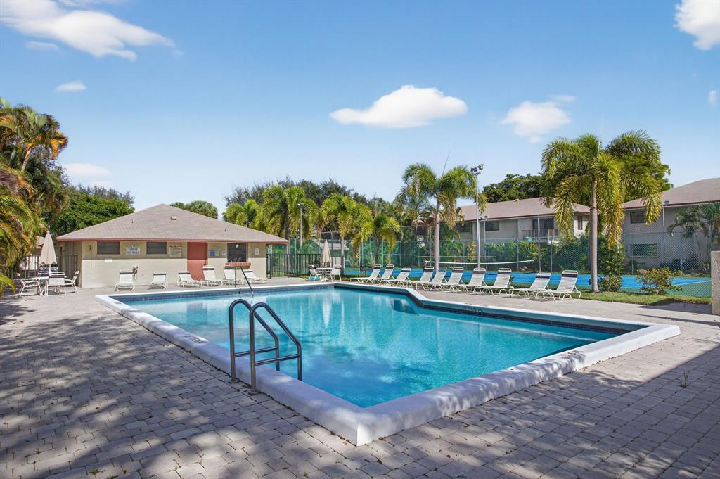 1759 Northeast 40th Place, Unit 604 Pompano Beach, FL 33064 - Photo 21 of 24 a view of a swimming pool with a patio