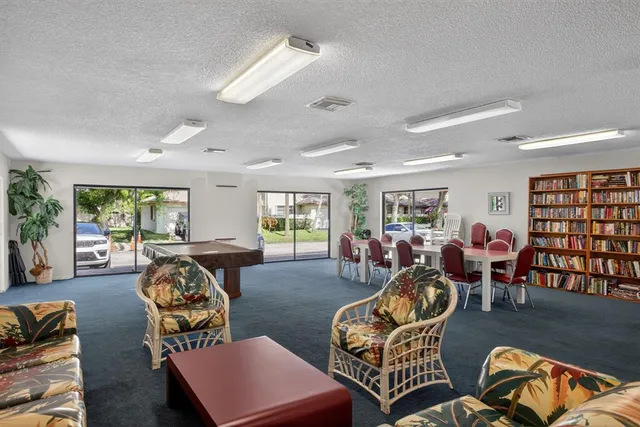 a living room with furniture a couch and large window