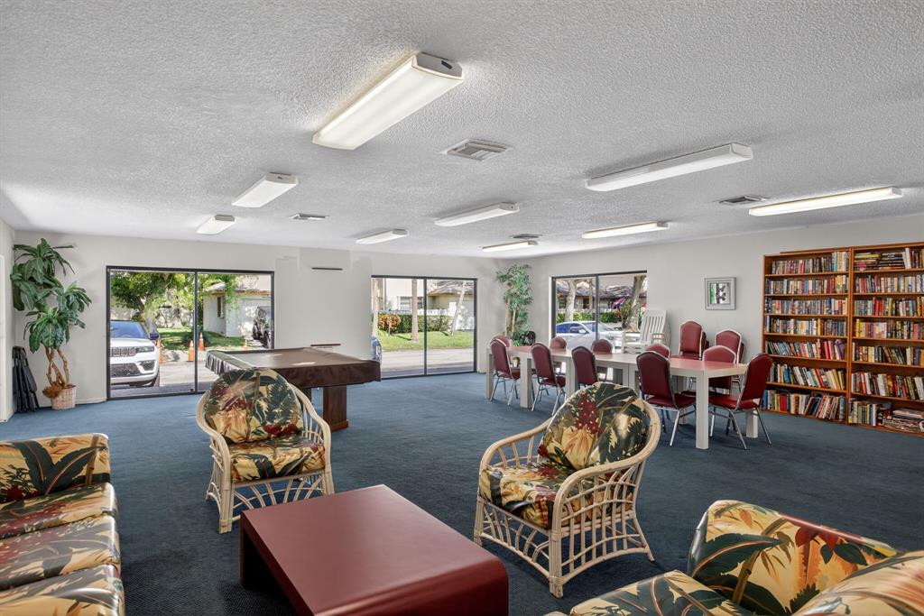 1759 Northeast 40th Place, Unit 604 Pompano Beach, FL 33064 - Photo 22 of 24 a living room with furniture a couch and large window