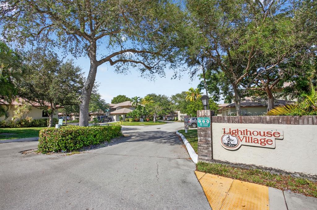1759 Northeast 40th Place, Unit 604 Pompano Beach, FL 33064 - Photo 24 of 24 a view of outdoor space with signage and flags