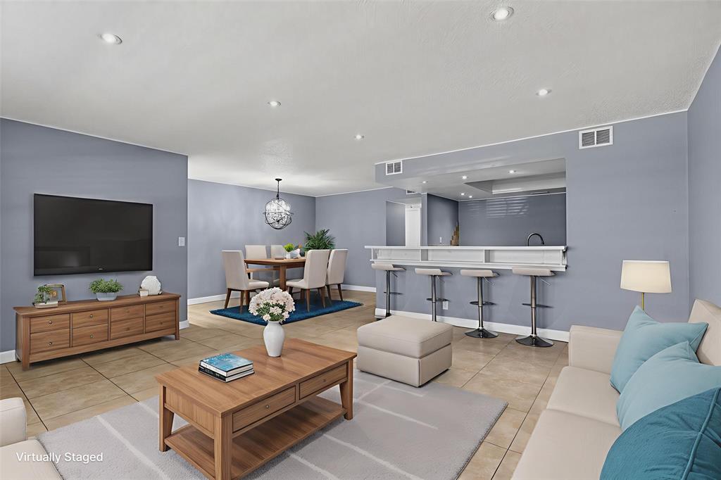 1759 Northeast 40th Place, Unit 604 Pompano Beach, FL 33064 - Photo 7 of 24 a living room with furniture and a flat screen tv