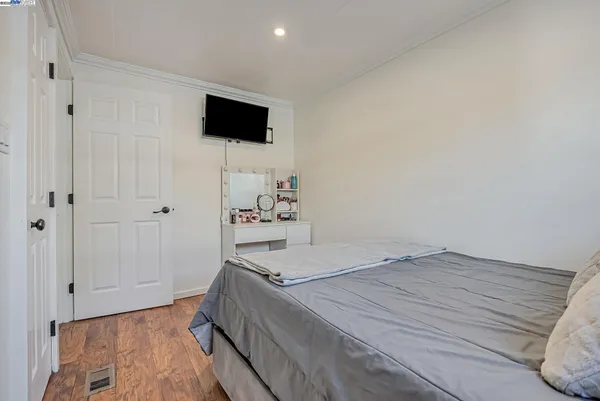 a room with a bed and a flat screen tv