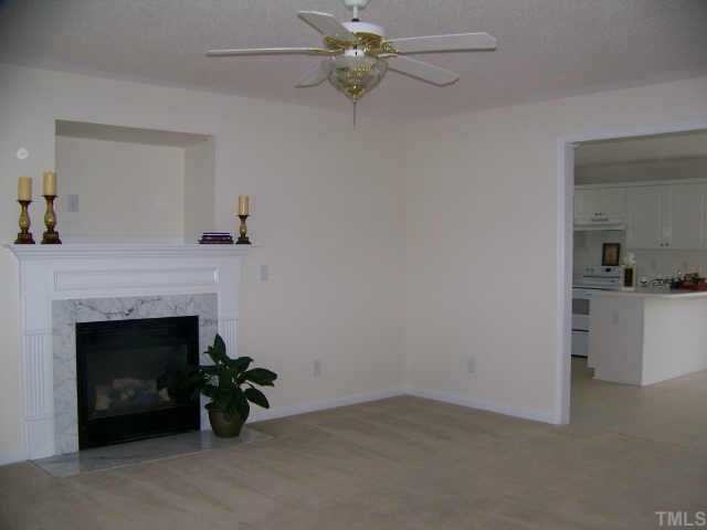 7117 Missionary Ridge Drive Raleigh, NC 27610 - Photo 2 of 12 a living room with furniture and a fireplace