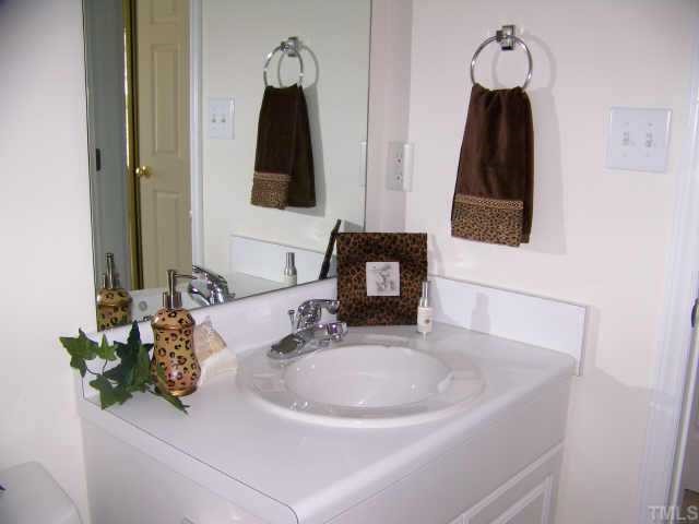 7117 Missionary Ridge Drive Raleigh, NC 27610 - Photo 7 of 12 a bathroom with a sink and a mirror