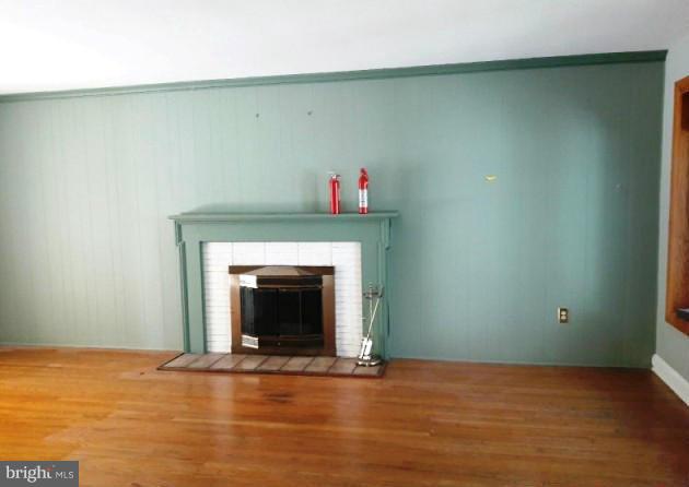500 Blick Drive Silver Spring, MD 20904 - Photo 8 of 15 a view of an empty room with wooden floor and a fireplace