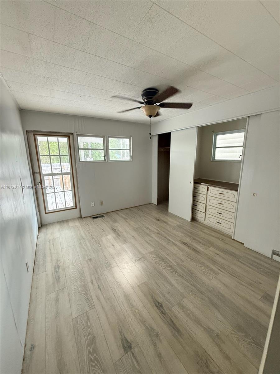 5374 Southeast Celestial Circle Stuart, FL 34997 - Photo 13 of 23 wooden floor in an empty room with a window