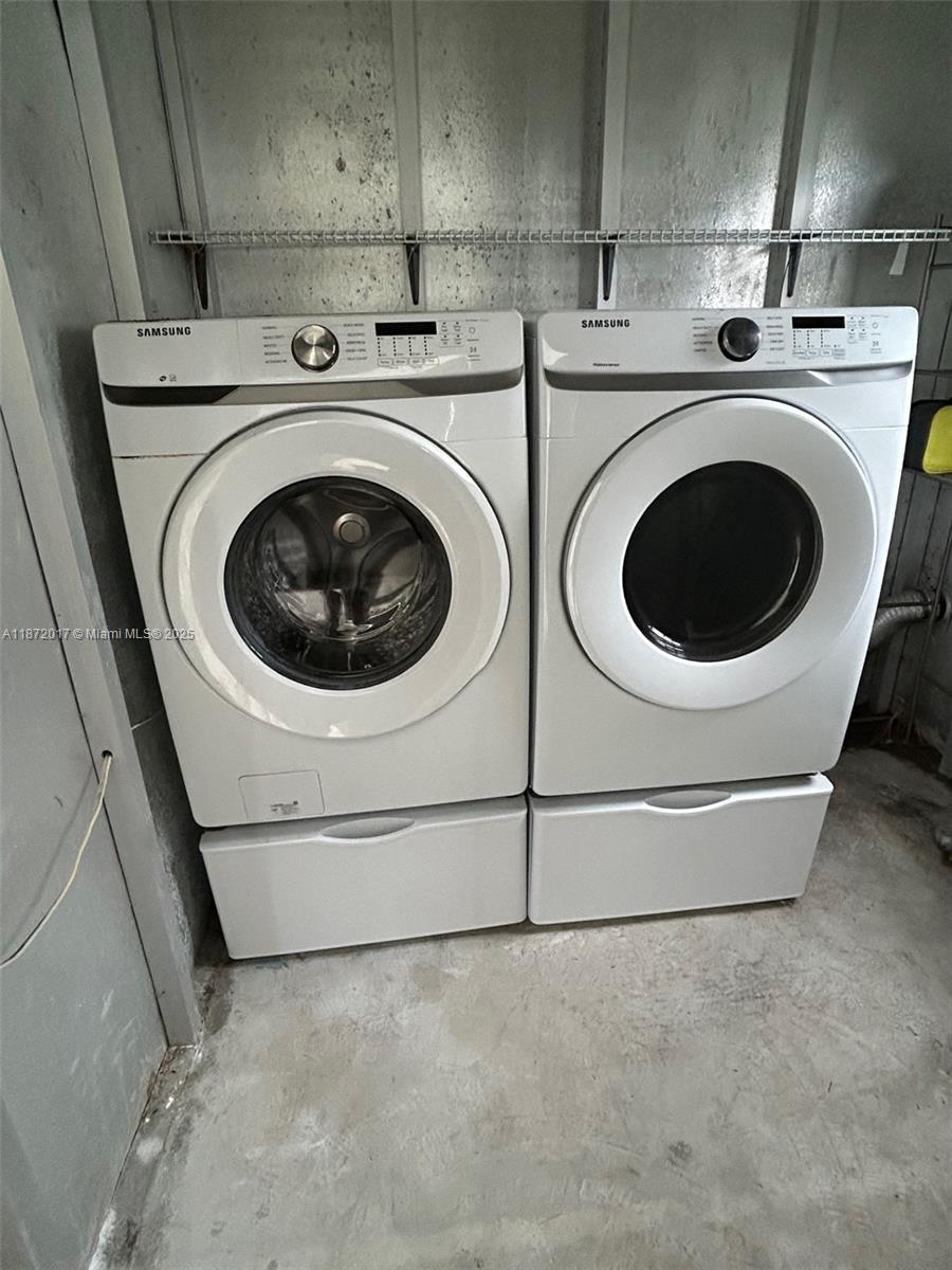 5374 Southeast Celestial Circle Stuart, FL 34997 - Photo 14 of 23 a utility room with dryer and washer