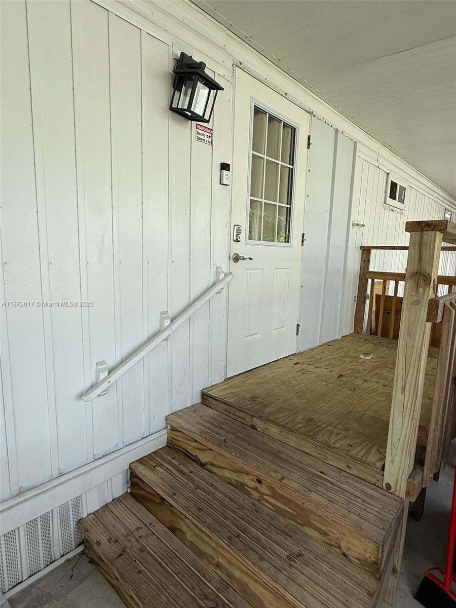 5374 Southeast Celestial Circle Stuart, FL 34997 - Photo 2 of 23 a view of a hallway with wooden floor and staircase