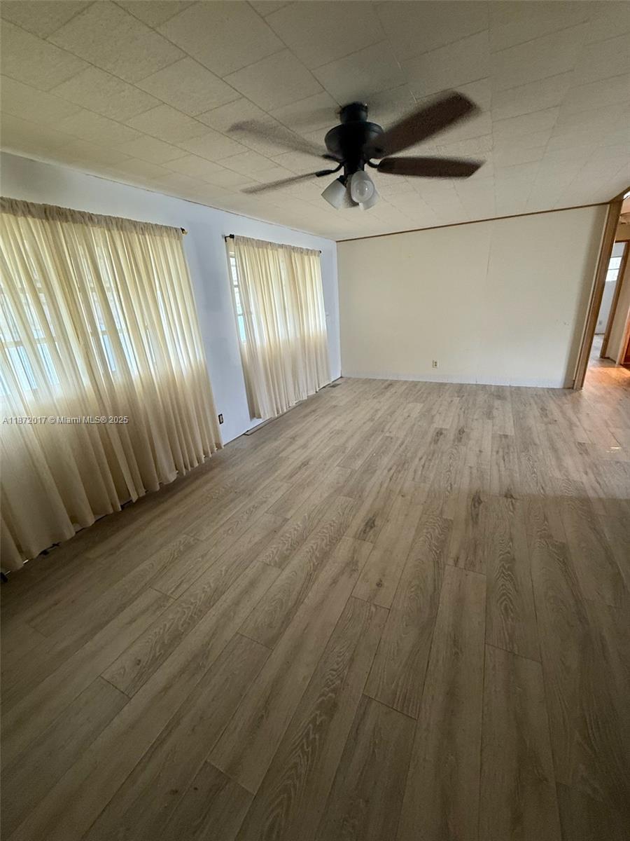 5374 Southeast Celestial Circle Stuart, FL 34997 - Photo 6 of 23 wooden floor in an empty room