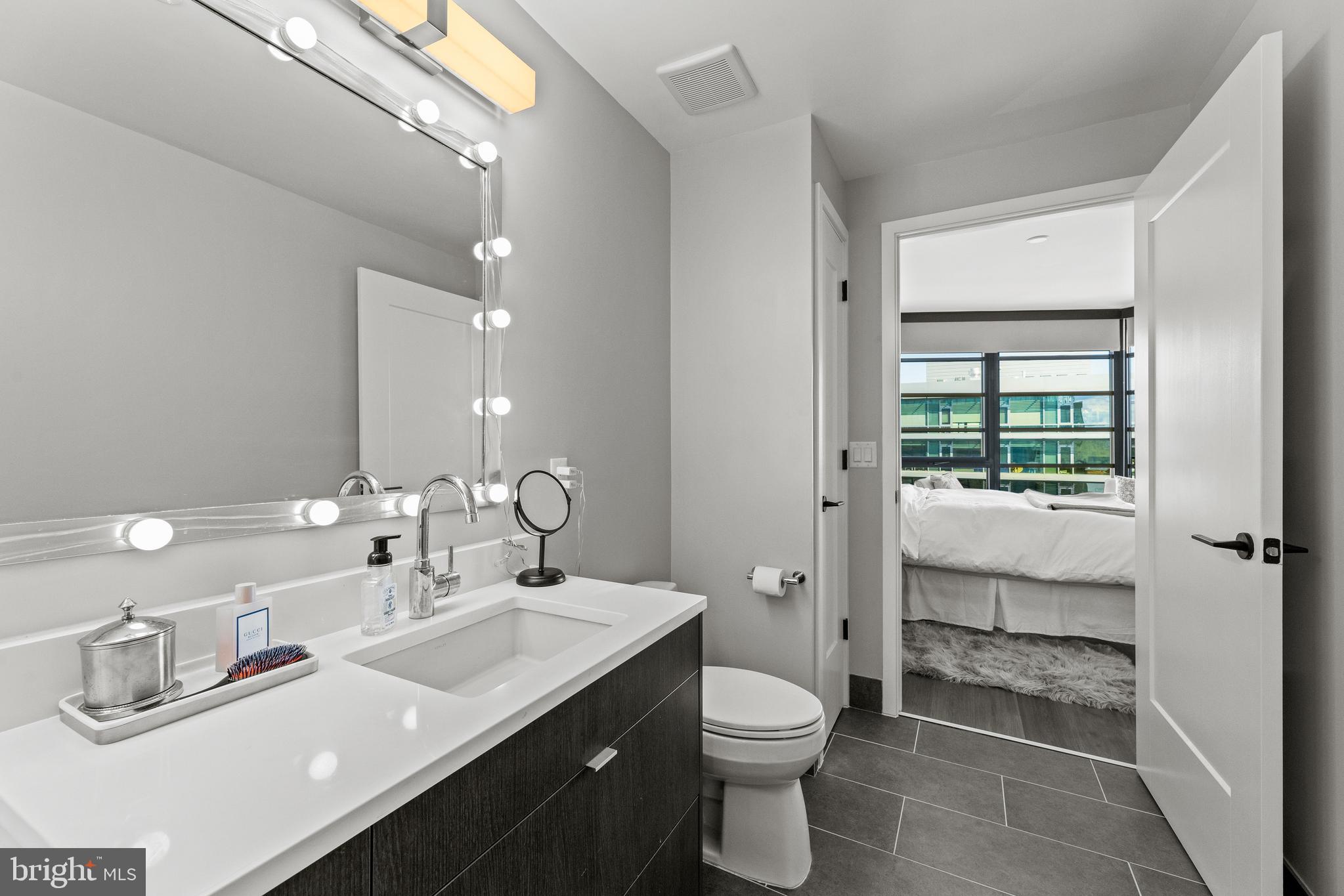1300 4th Street Southeast, Unit 915 Washington, DC 20003 - Photo 13 of 34 a bathroom with a double vanity sink toilet and shower
