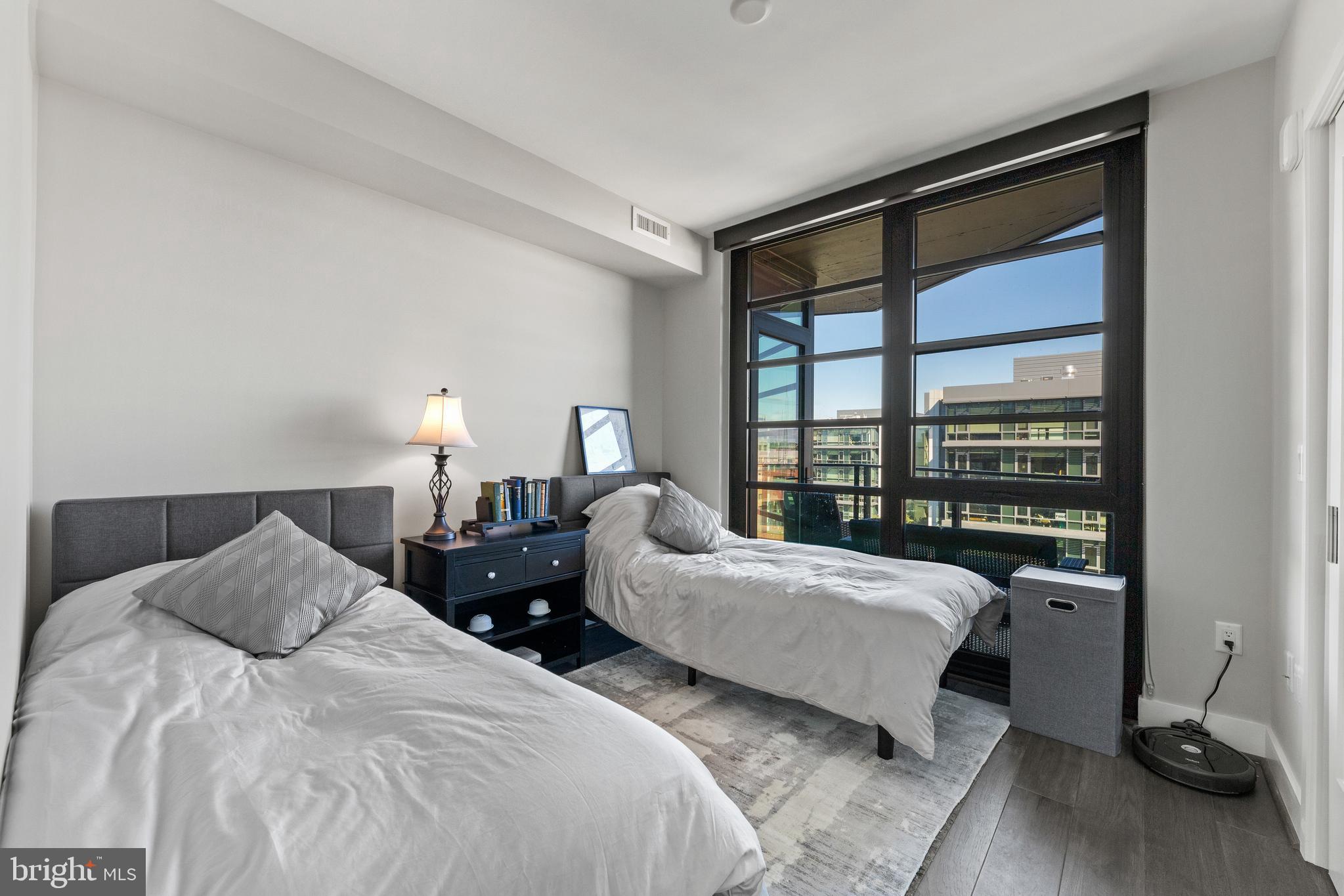 1300 4th Street Southeast, Unit 915 Washington, DC 20003 - Photo 14 of 34 a bedroom with two beds and a large window