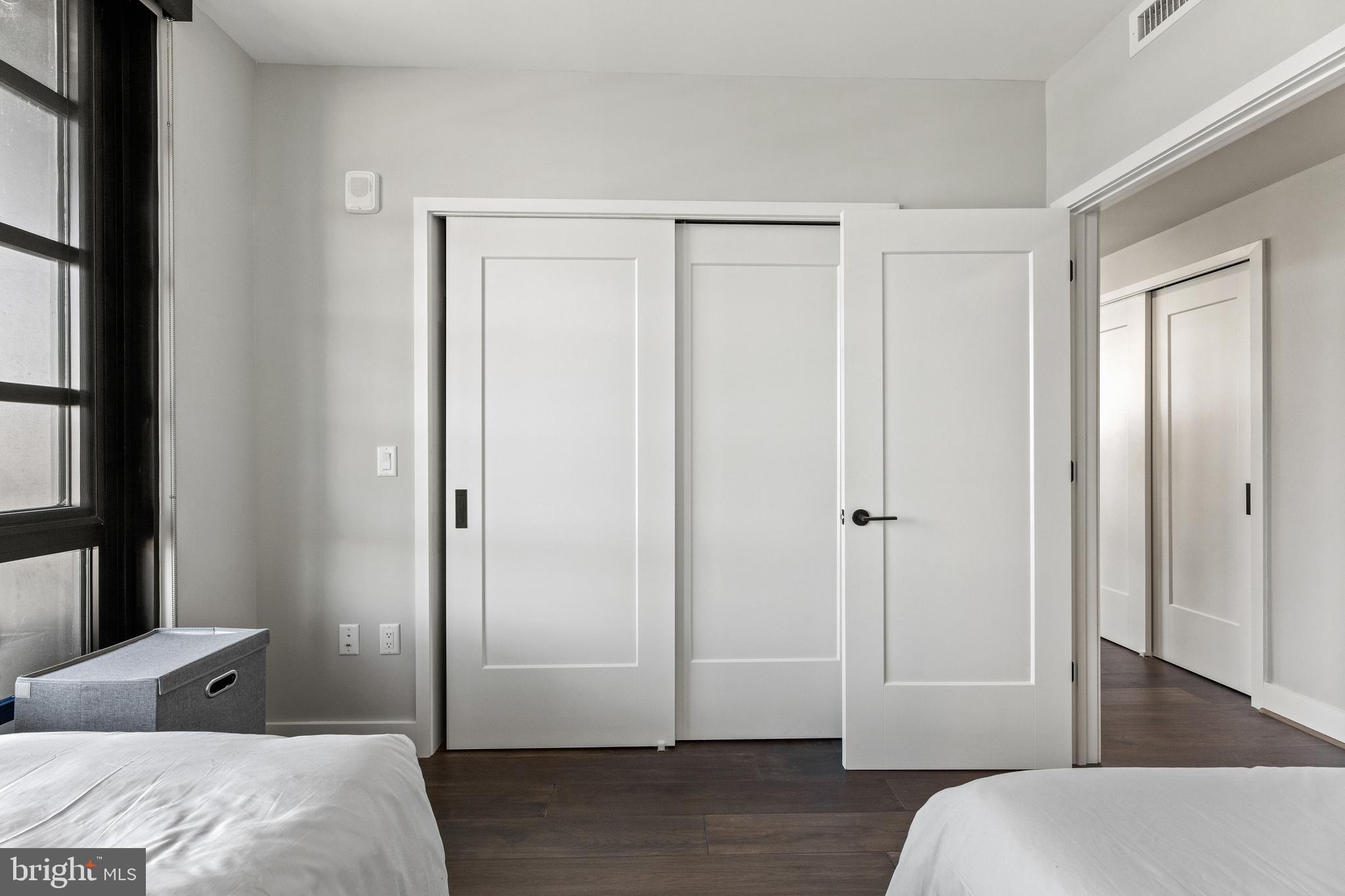 1300 4th Street Southeast, Unit 915 Washington, DC 20003 - Photo 15 of 34 a bedroom with a bed and wooden floor