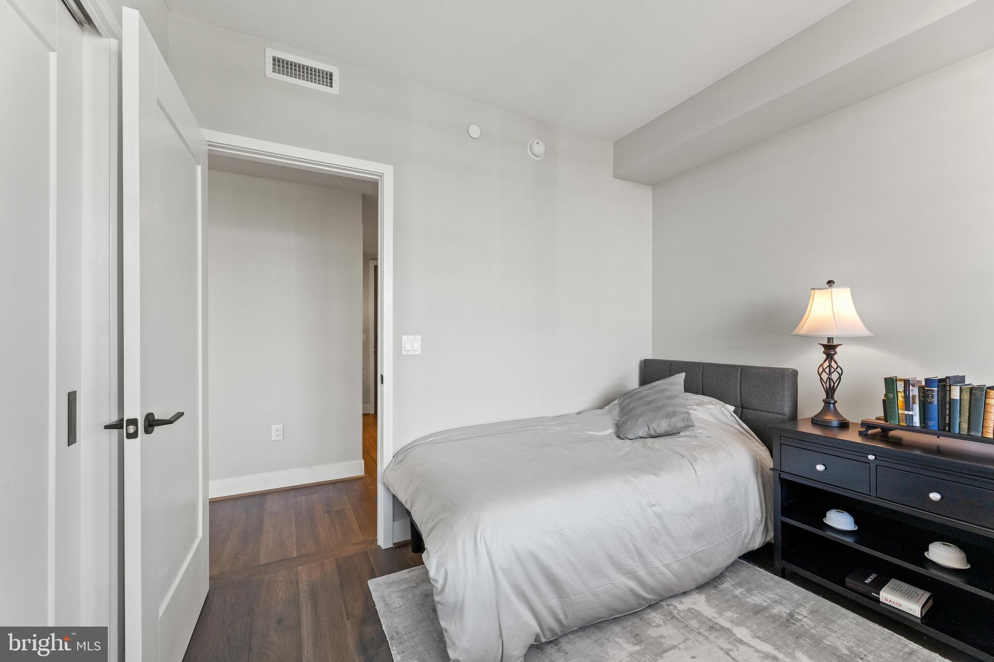 1300 4th Street Southeast, Unit 915 Washington, DC 20003 - Photo 16 of 34 a bedroom with a bed and a lamp