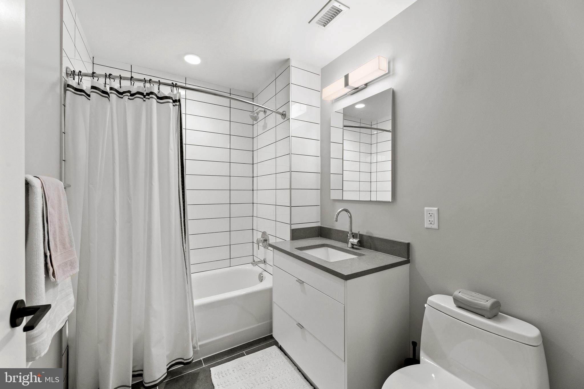 1300 4th Street Southeast, Unit 915 Washington, DC 20003 - Photo 17 of 34 a bathroom with a sink toilet and shower