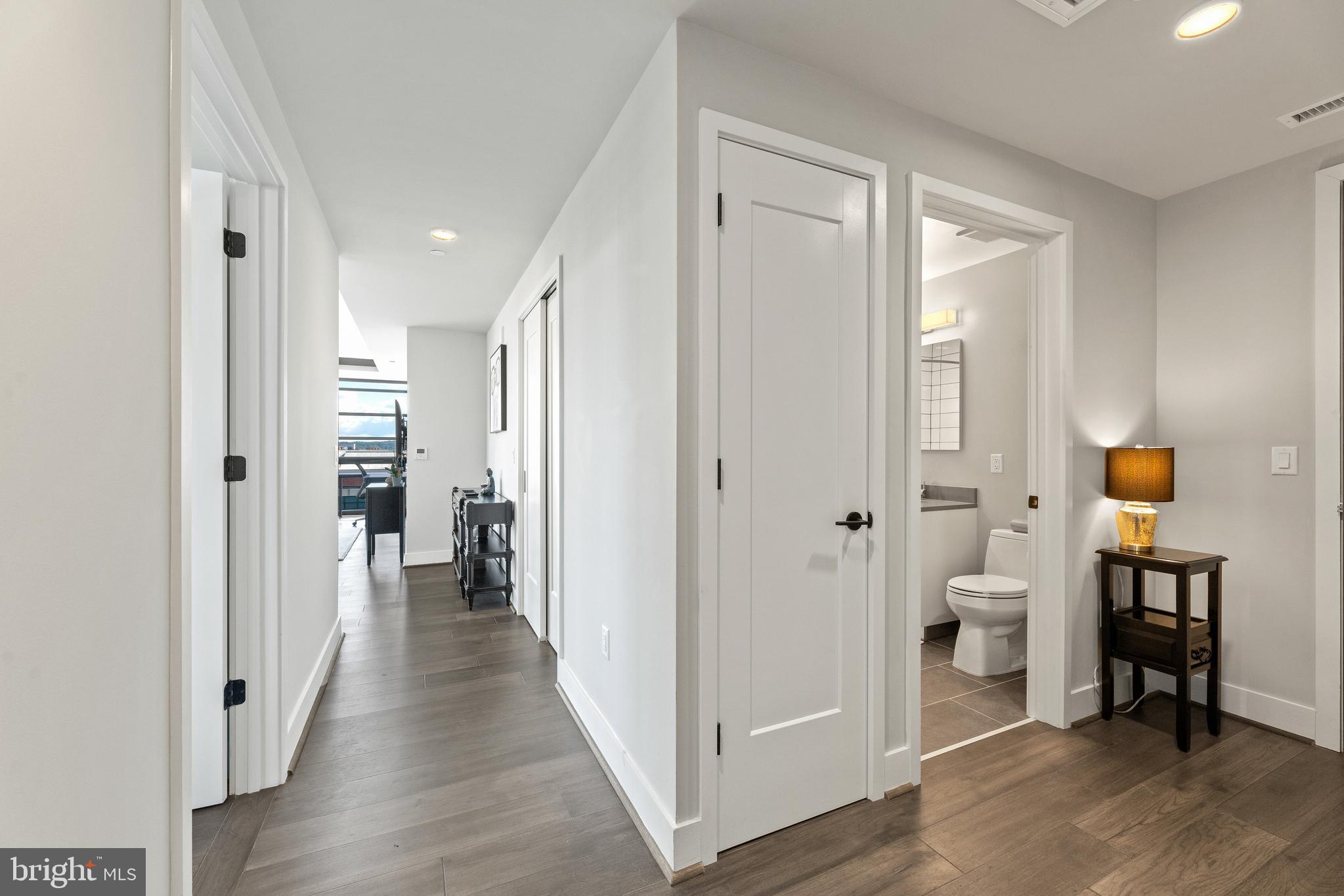 1300 4th Street Southeast, Unit 915 Washington, DC 20003 - Photo 18 of 34 a view of a hallway with wooden floor and a bathroom