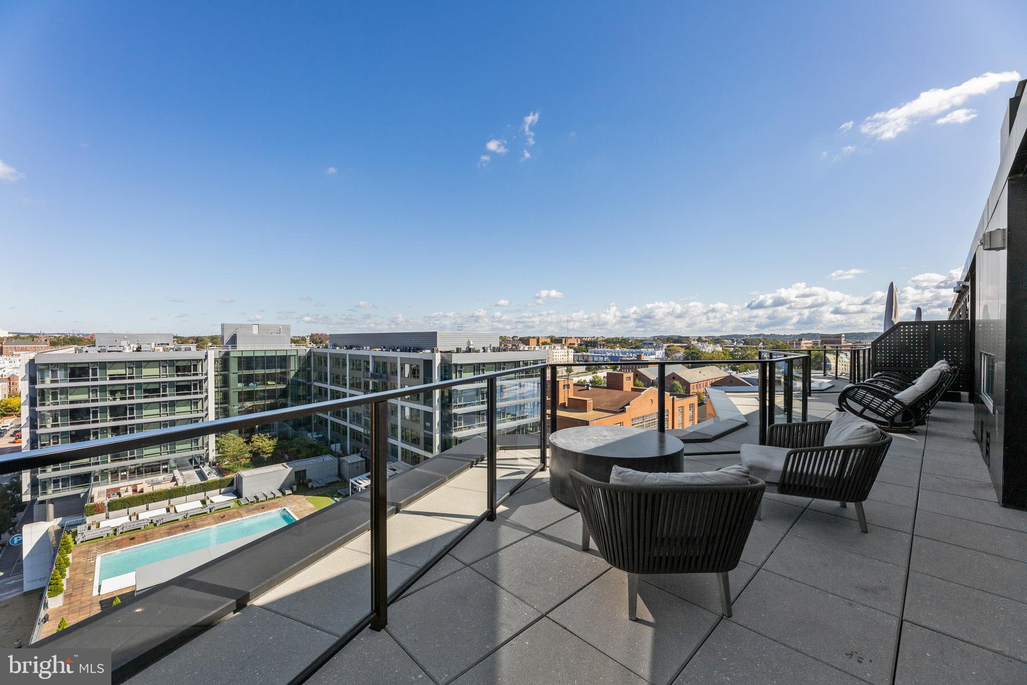 1300 4th Street Southeast, Unit 915 Washington, DC 20003 - Photo 26 of 34 a roof deck with outdoor seating and city view