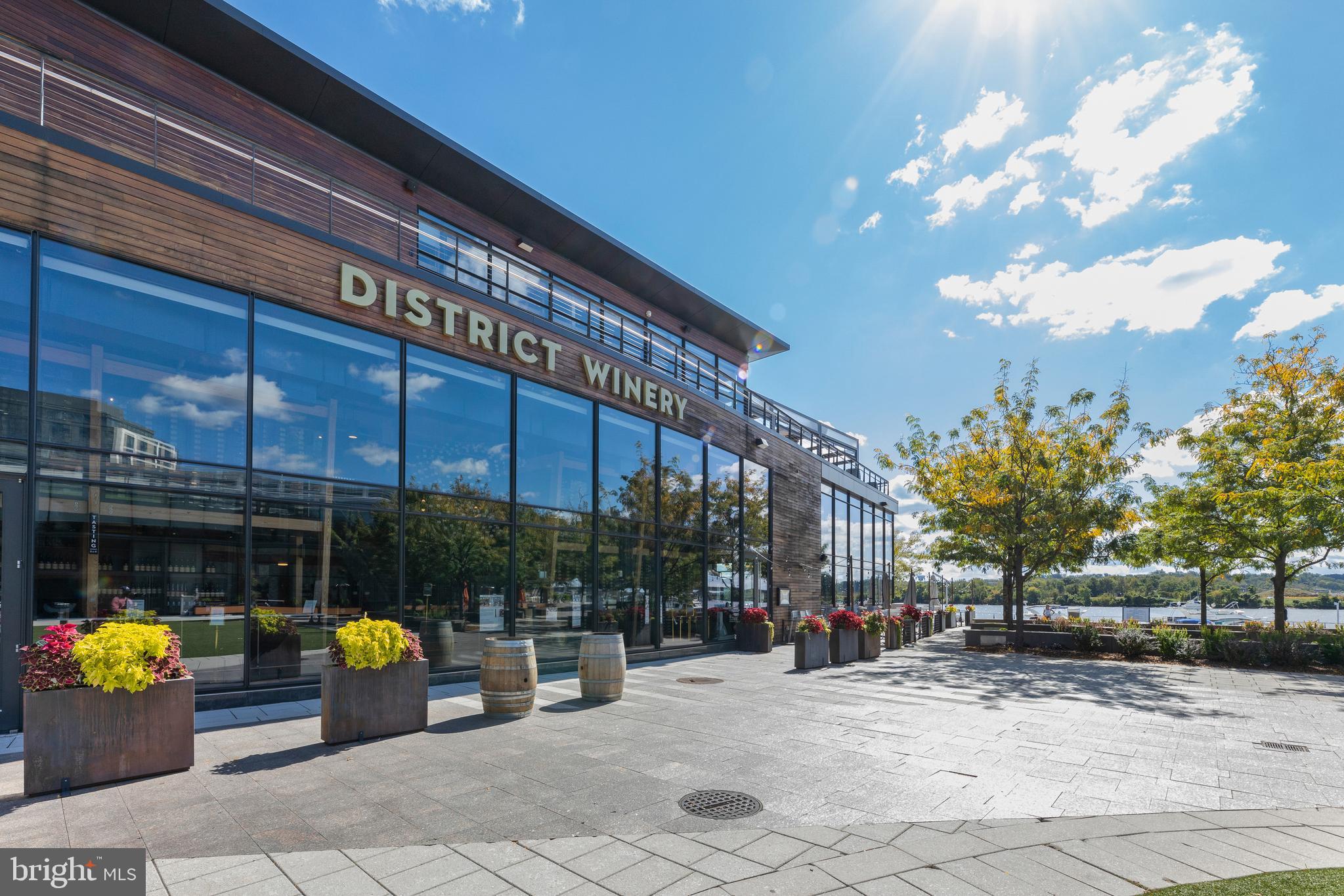 1300 4th Street Southeast, Unit 915 Washington, DC 20003 - Photo 34 of 34 a view of a patio with dining table and chairs under an umbrella