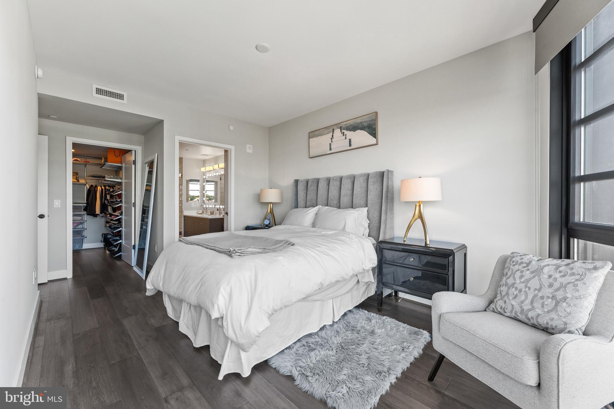 1300 4th Street Southeast, Unit 915 Washington, DC 20003 - Photo 9 of 34 a spacious bedroom with a bed a couch and a window