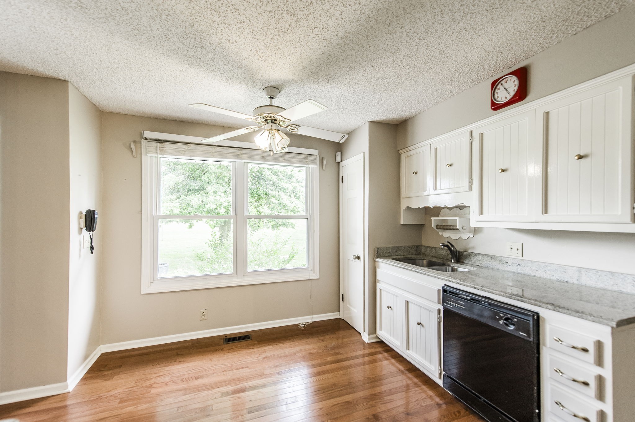 200 Haynes Road Portland, TN 37148 - Photo 26 of 64 a kitchen with granite countertop a stove a sink and wooden floor