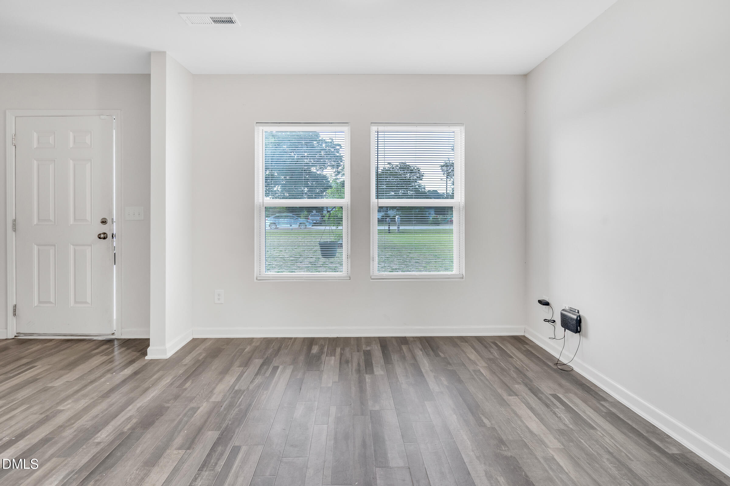 3146 Stoney Hill Church Road Bailey, NC 27807 - Photo 10 of 26 an empty room with wooden floor and windows