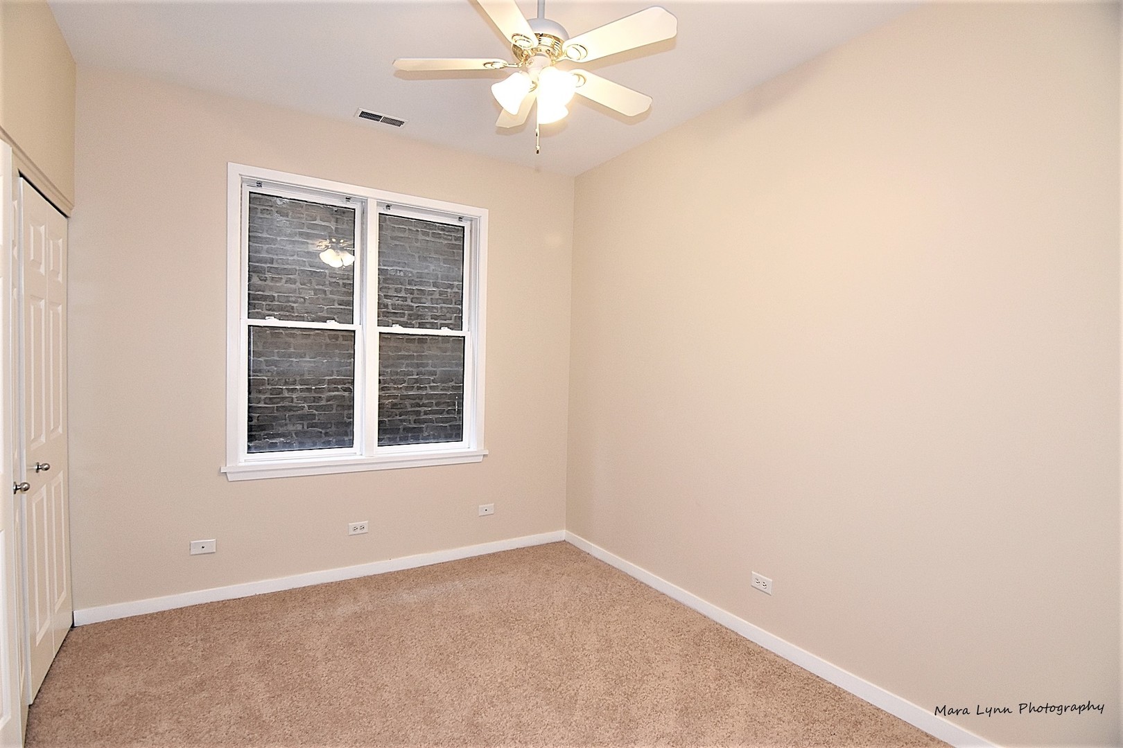 1311 West Fillmore Street, Unit B Chicago, IL 60607 - Photo 12 of 25 an empty room with a window and a fan