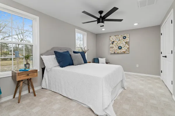 a bedroom with a large bed and a window