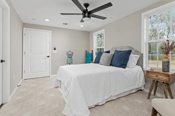 a bedroom with a large bed and a window