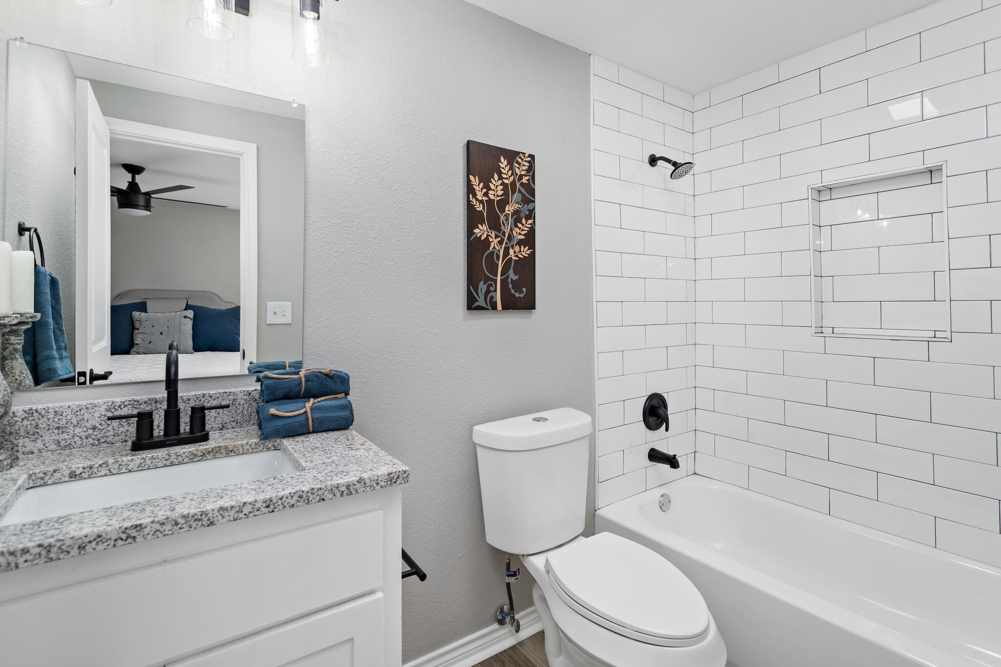 2320 Delaware Street Beaumont, TX 77703 - Photo 16 of 27 a bathroom with a granite countertop toilet a sink and bathtub