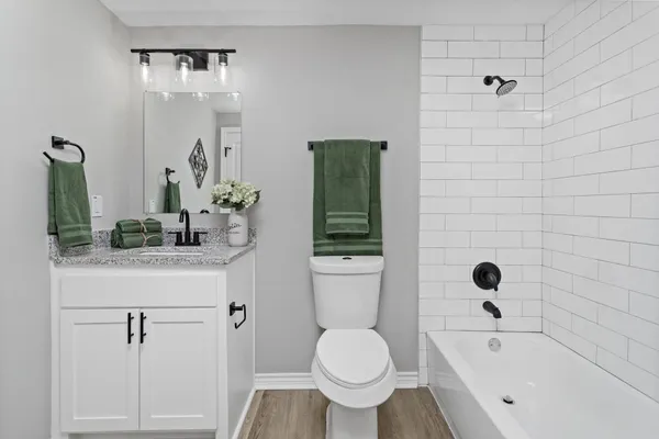 a bathroom with a toilet sink and shower