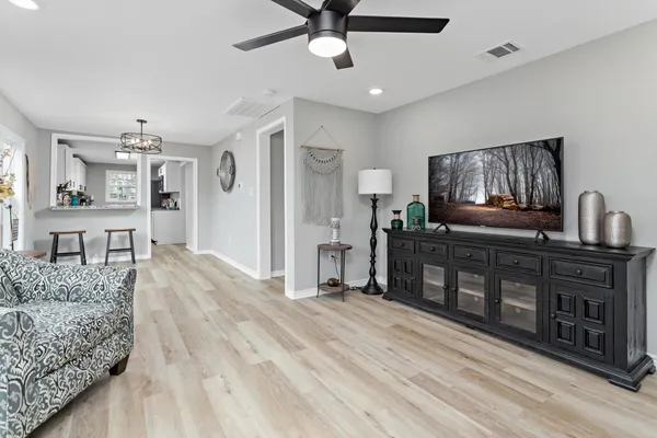 a living room with furniture and flat screen tv