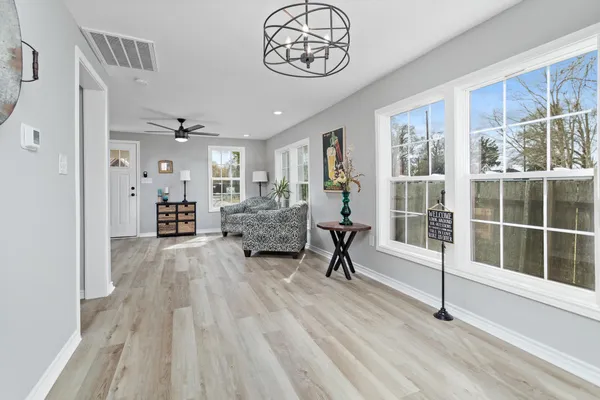 a view of a livingroom with furniture and a window